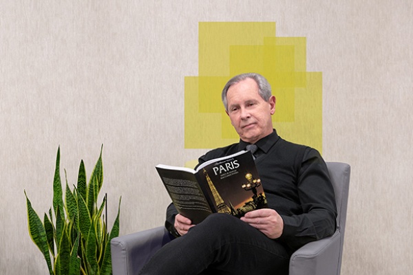 man sitting reading french book